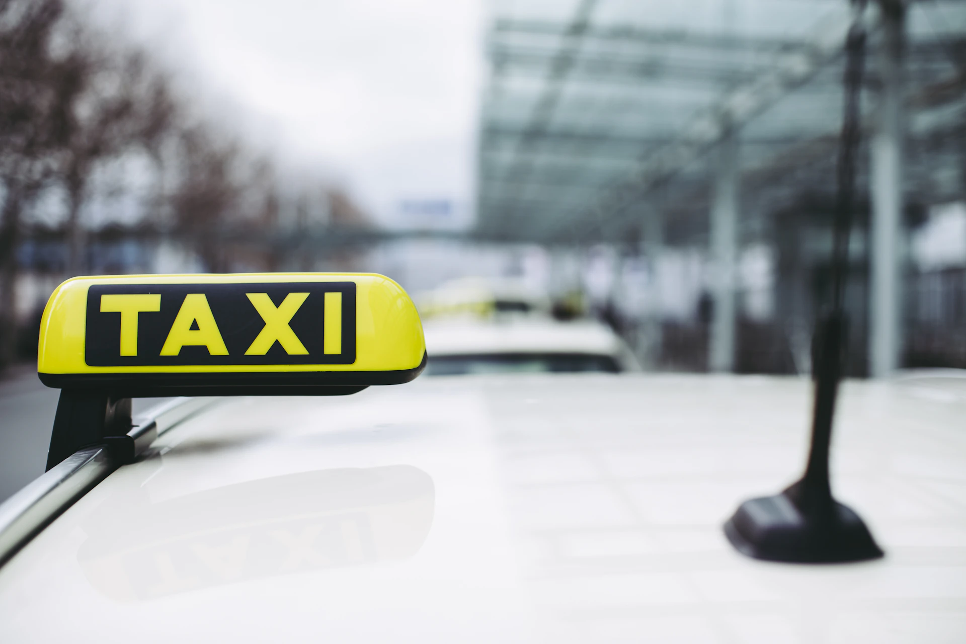 Crowded airport arrivals hall with taxi touts