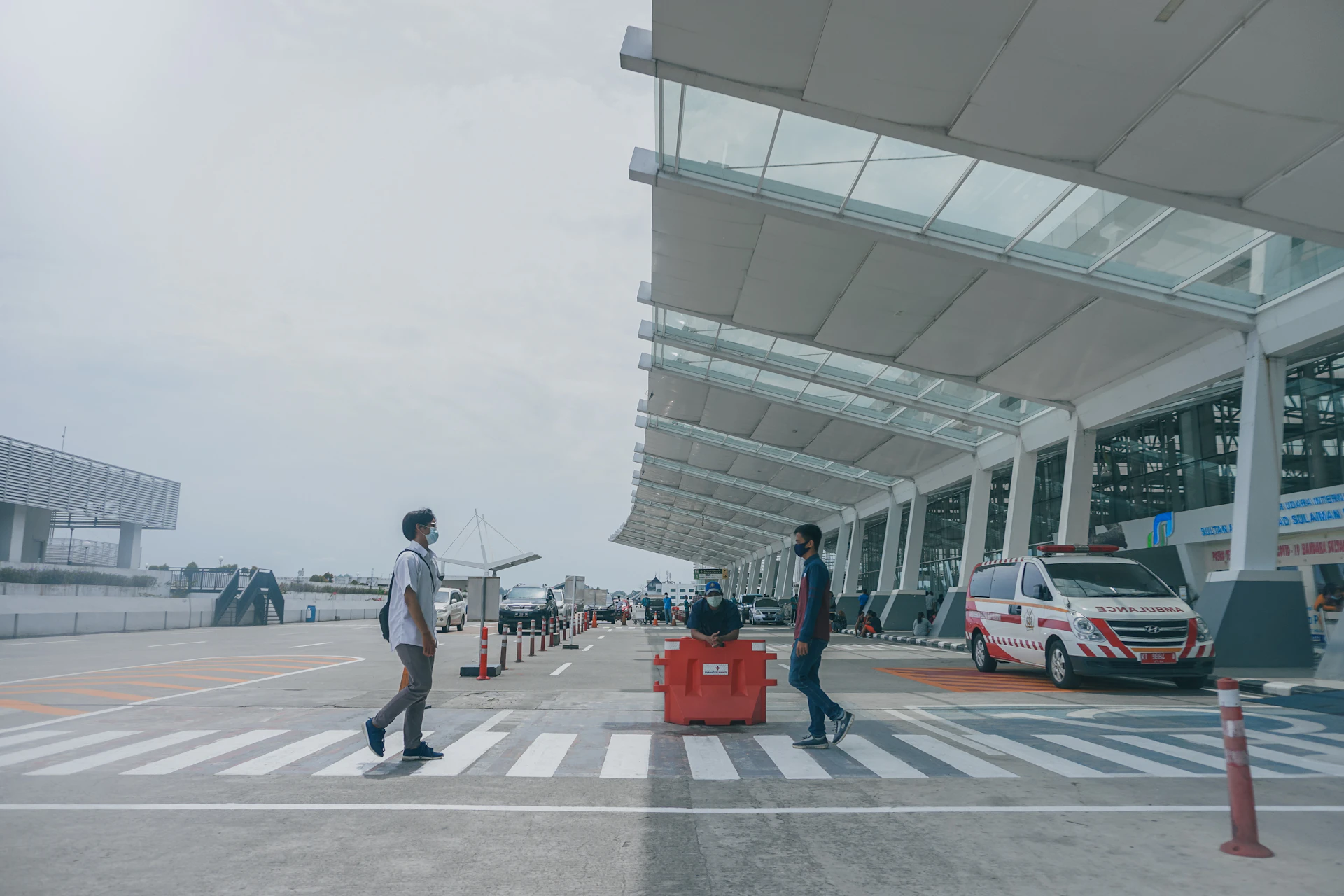 Three different transfer vehicles parked in a row at an airport