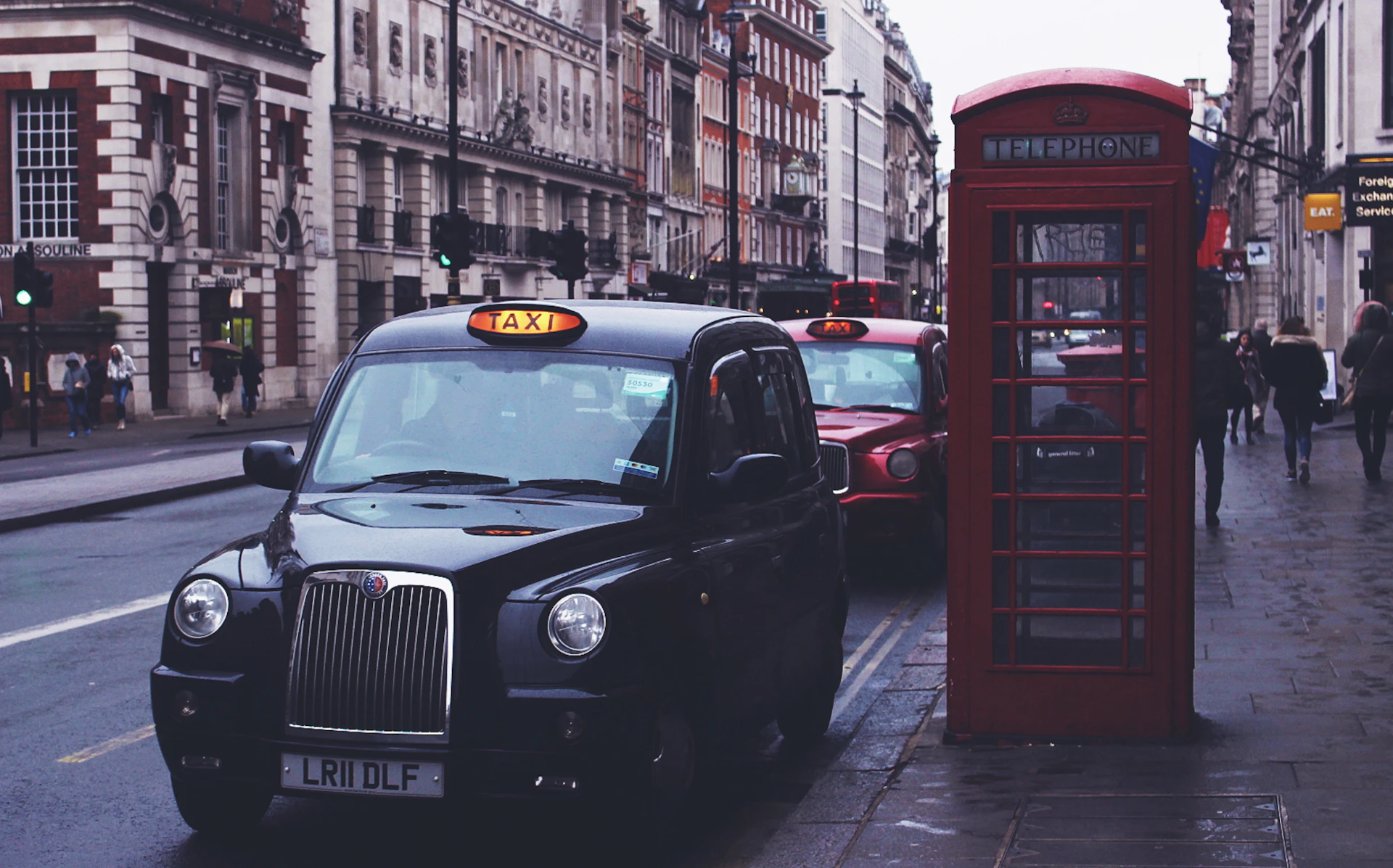 A black London taxi outside Heathrow Terminal 5