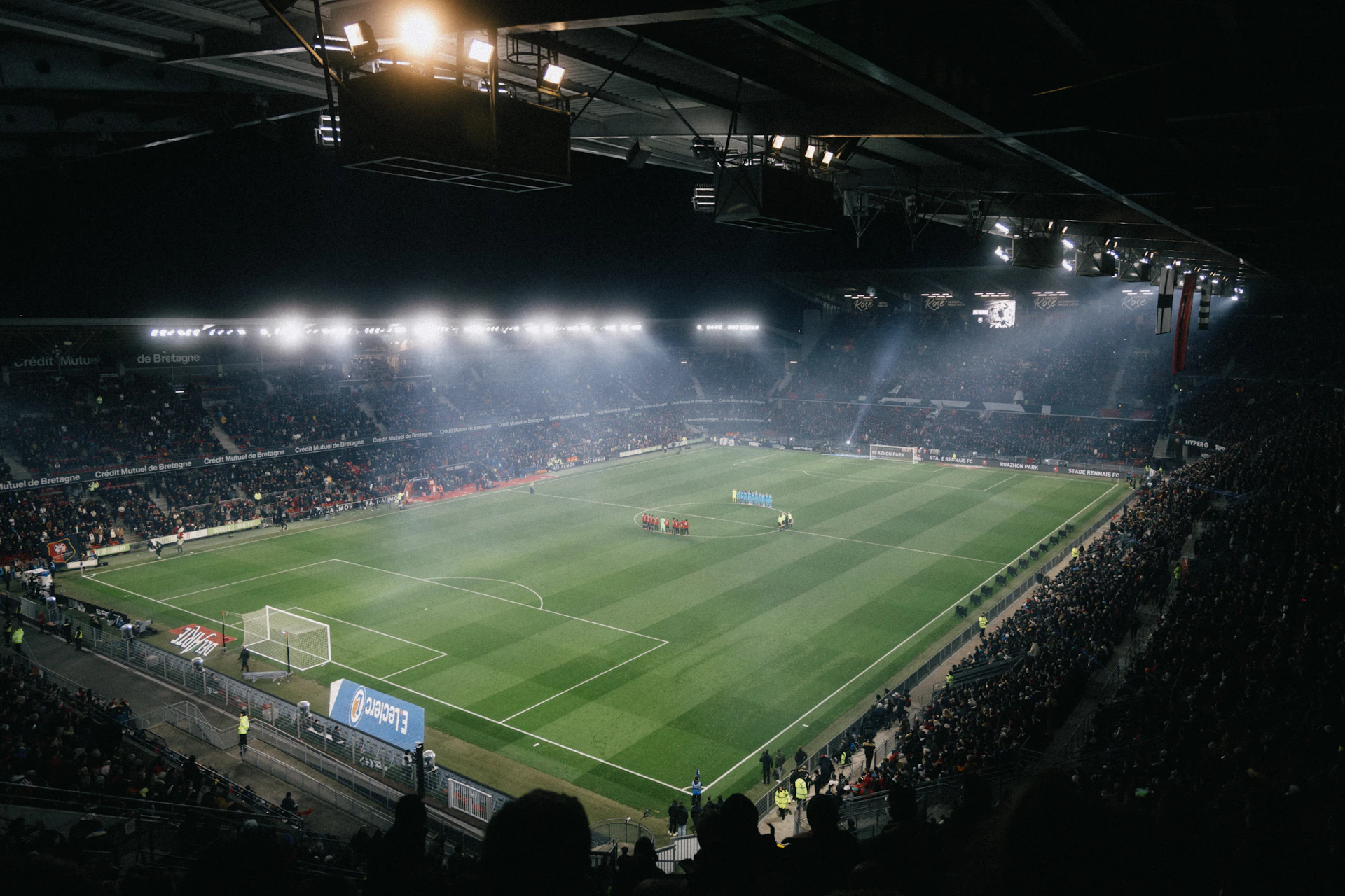 Aerial view of a stadium illuminated for an evening match